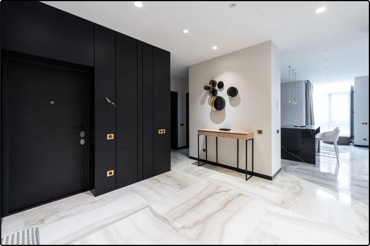 House interior showing a hallway that flows into an open kitchen with contemporary design elements.